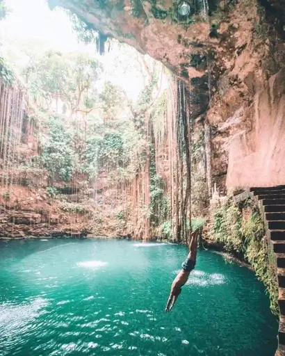 girl taking a picture at cenote ik kil