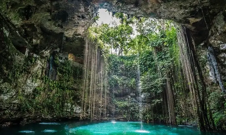 Panoramic view of Ik Kil cenote surrounded by jungle